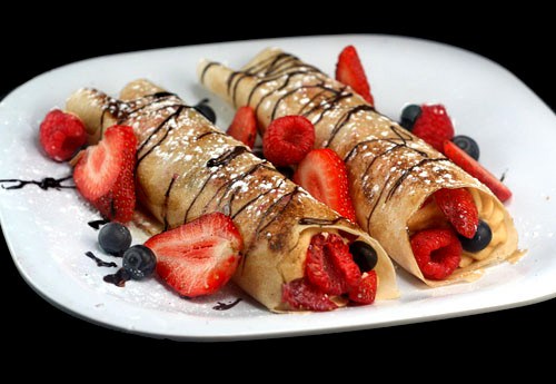 fruit filled crepes with chocolate drizzle