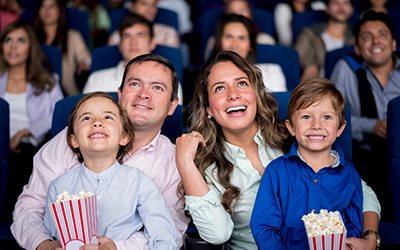 Happy family at the cinema watching a movie