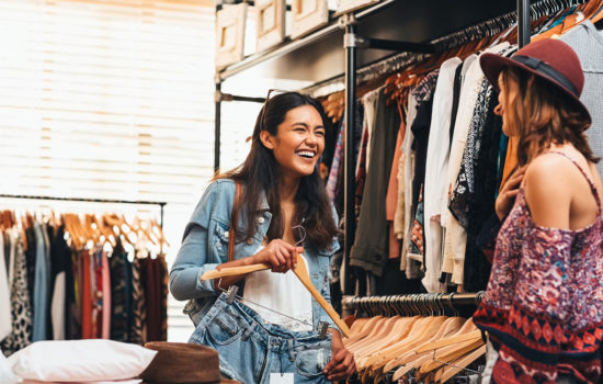 Shot of two friends shopping in a clothing boutique